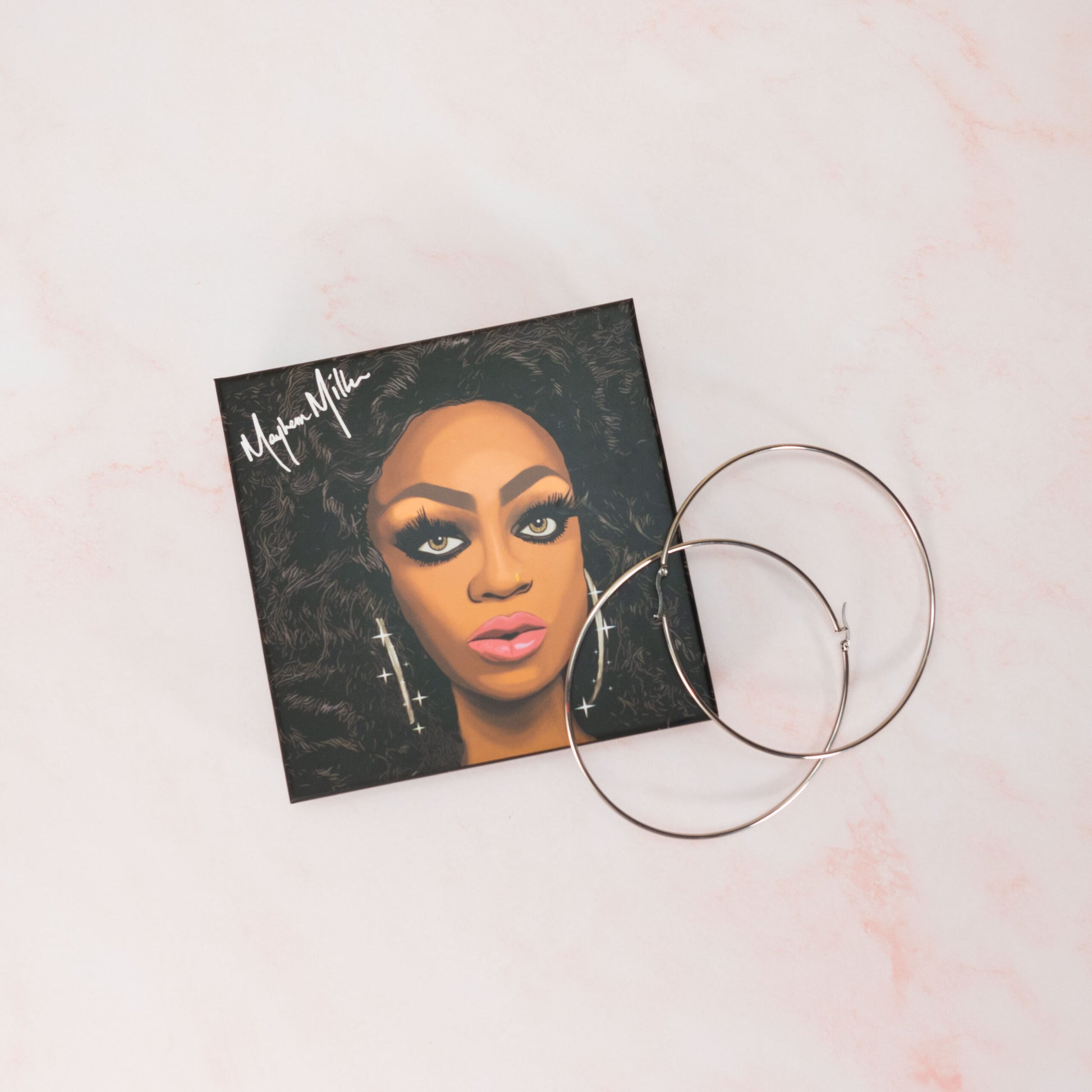 Mayhem Miller's signature hoop earrings in the Drag Society box